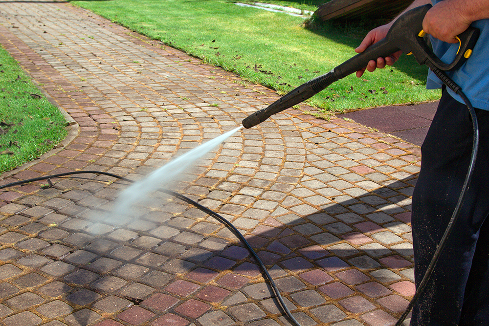 Pressure Washing 101: Everything You Need to Know About This Cleaning Method 9 cleaning street with high pressure power washer